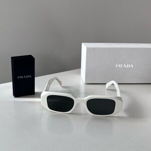 Authentic Prada sunglasses in white. Brand new with box and accessories.